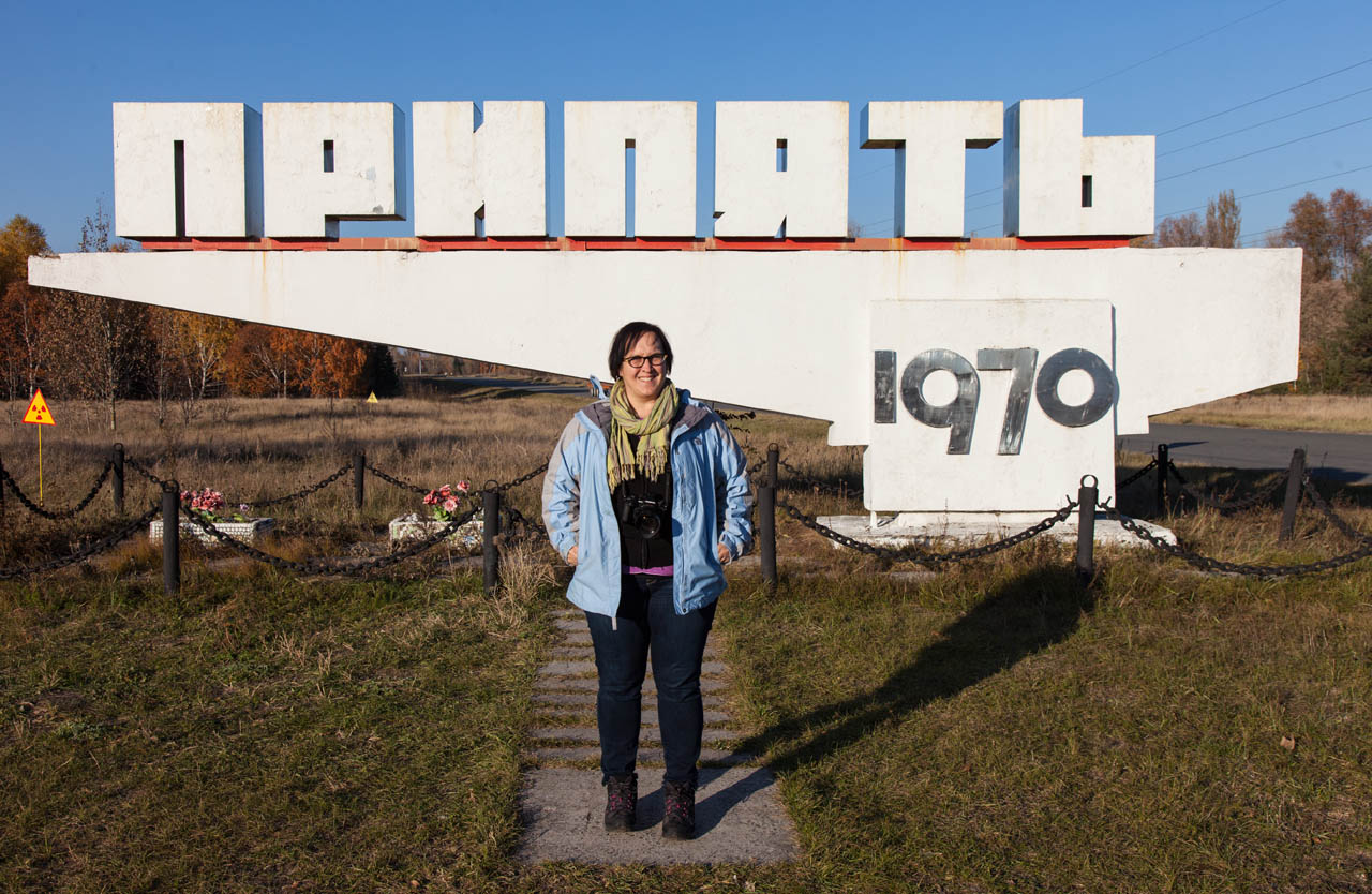 Neeley standing in fron the Pripyat 1970 sign