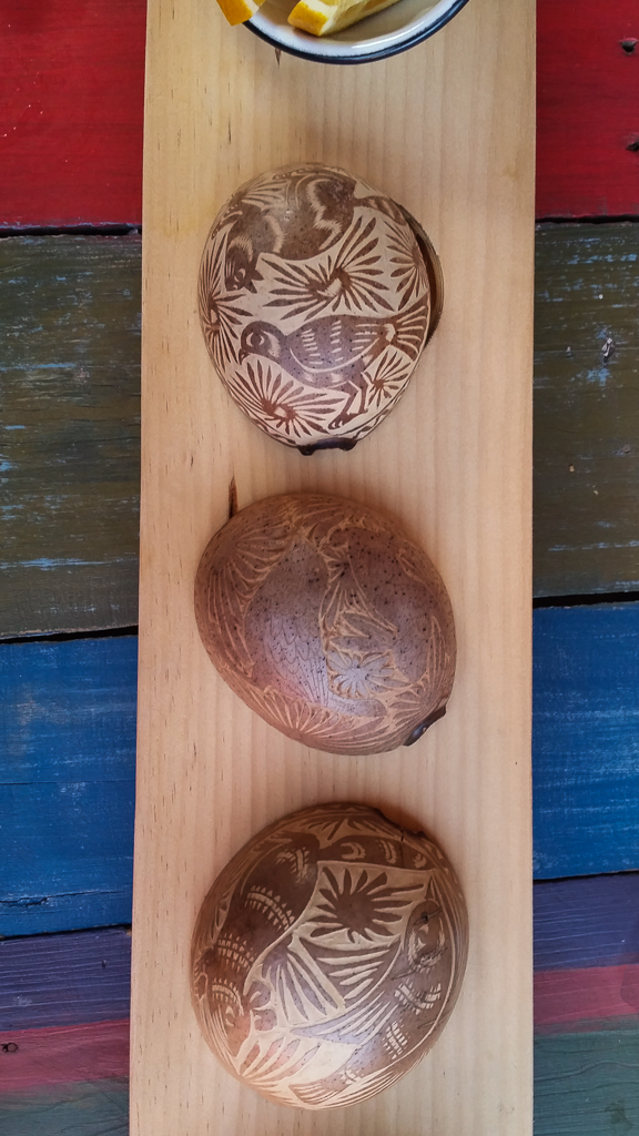 The carving on the gourds used for the mezcal tasting.